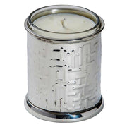 White candle in a decorative silver holder on a white background