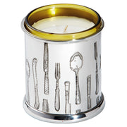 Candle in a silver container with cutlery designs on a white background