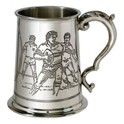 Silver tankard with engraved design of three figures on a white background