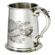 Silver tankard with intricate design on a white background