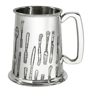 Silver tankard with engraved cutlery design on a white background