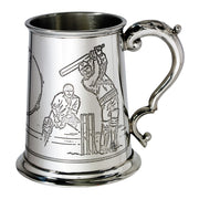 Silver tankard with engraved cricket scenes on a white background