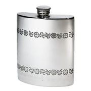 Silver hip flask with floral patterns on a white background