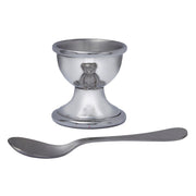 Silver egg cup with teddy bear design and matching spoon on a white background