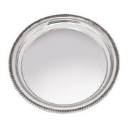 Round silver tray with beaded edge on a white background