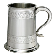 Silver tankard with Celtic knot patterns on a white background