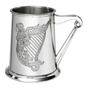 Silver tankard with a decorative design of a harp and mermaid on a white background
