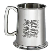 Silver tankard with engraved design on a white background