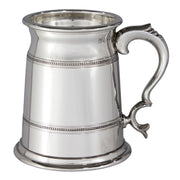 Silver tankard with decorative handle on a white background