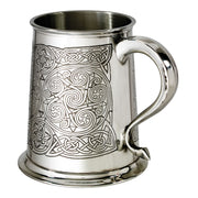Silver tankard with intricate Celtic knot design on a white background