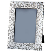 Decorative photo frame with black floral pattern on a white background