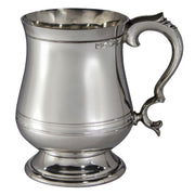 Silver tankard with a decorative handle on a white background