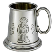 Silver tankard with a engraved design of a boy in pajamas on a white background