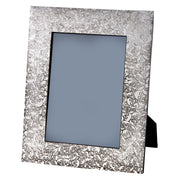 Decorative silver photo frame with intricate patterns on a white background