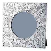 Decorative metallic frame with intricate patterns and a central round opening.