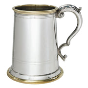 Silver tankard with a decorative handle on a white background