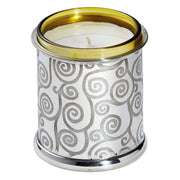 Candle in a decorative metal holder with gold rim on a white background