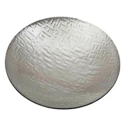 Round metallic object with textured surface on a white background