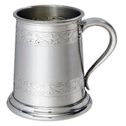 Silver tankard with Celtic knot patterns on a white background