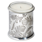 Candle in a silver container with leaf patterns on a white background