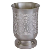 Silver decorative cup with intricate patterns on a white background