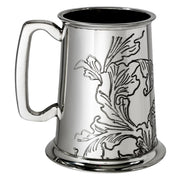 Silver tankard with floral engraving on a white background