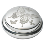Silver round object with butterfly designs on a white background