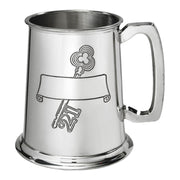 Silver tankard with engraved design on a white background