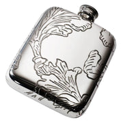Silver hip flask with floral engraving on a white background