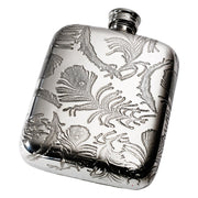 Silver flask with intricate leaf patterns on a white background