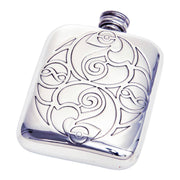 Silver hip flask with intricate Celtic design on a white background