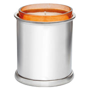 Candle in a silver container with an orange lid on a white background