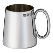 Silver mug with engraved symbols on a white background