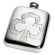 Silver hip flask with intricate designs on a white background