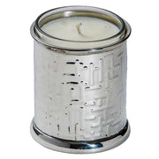 White candle in a decorative silver holder on a white background