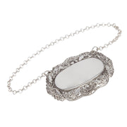 Silver necklace with an ornate pendant on a white background