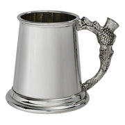 Silver tankard with acorn handle on a white background