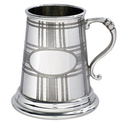 Silver tankard with plaid pattern on a white background