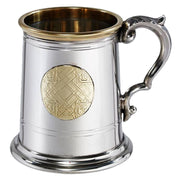 Silver tankard with a gold emblem on a white background