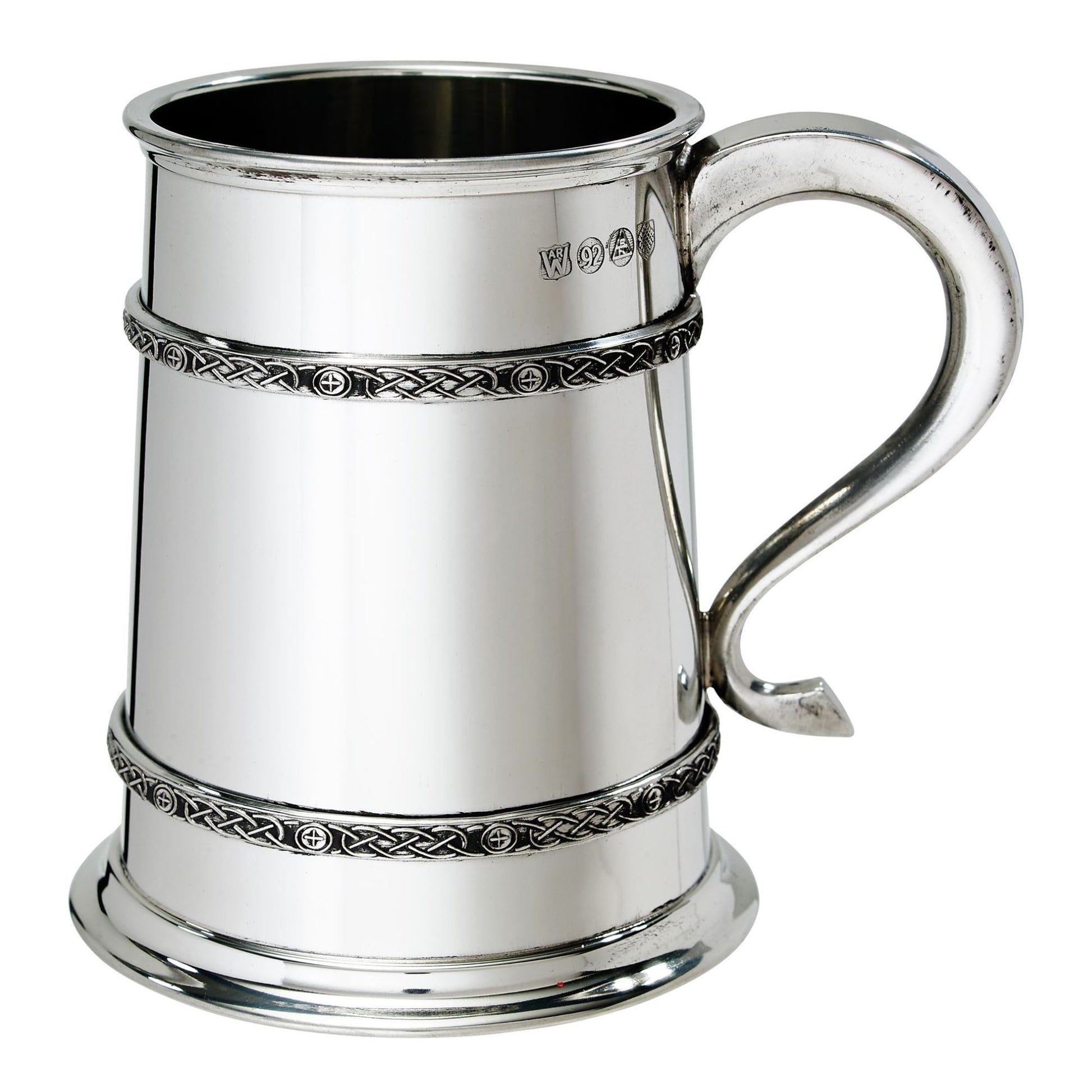 Silver tankard with Celtic knot designs on a white background