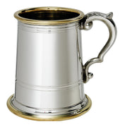 Silver tankard with gold interior and base on a white background