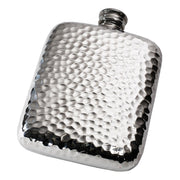 Silver hammered hip flask on a white background