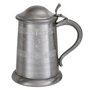 Pewter tankard with embossed design on a white background