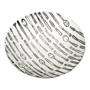 Round ceramic plate with black and white cutlery pattern on a white background