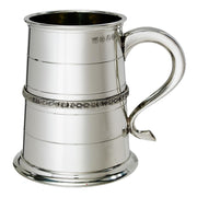 Silver tankard with decorative band and handle on a white background