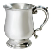 Silver mug with decorative handle on a white background